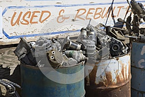 Sign And Rusty Barrels In Junkyard photo