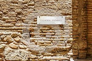 The sign saying Palacios Nazaries what translates to Nasrid palaces in Alhambra palace complex, Granada, Spain photo