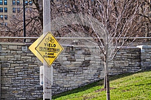 Sign saying: Yield to Pedestrians Please Dismount