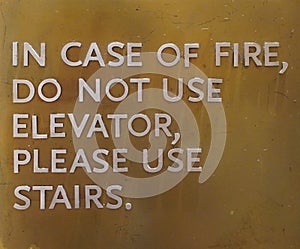 A sign that says, In Case Of Fire, Do Not Use Elevator, Please Use Stairs, which direct people of what to do in case of an fire