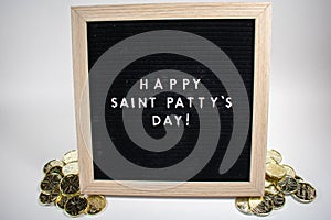 A Sign That Says Happy Saint Patty`s Day With Gold Coins