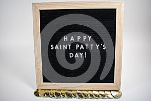 A Sign That Says Happy Saint Patty`s Day With Gold Coins