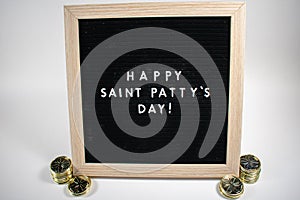 A Sign That Says Happy Saint Patty`s Day With Gold Coins