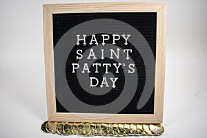 A Sign That Says Happy Saint Patty`s Day With Gold Coins