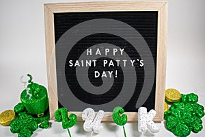 A Sign That Says Happy Saint Patty`s Day With Saint Patty`s Day Props Around It