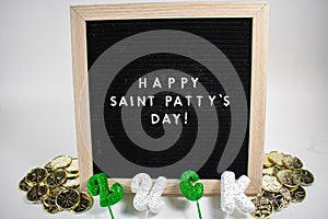 A Sign That Says Happy Saint Patty`s Day With Saint Patty`s Day Props Around It