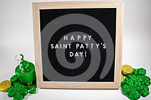 A Sign That Says Happy Saint Patty`s Day With Saint Patty`s Day Props Around It