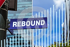 An sign that says rebound on a post and a blended bar chart trending upward.