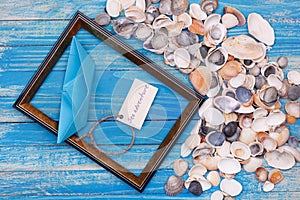Sign Sea adventure and paper Boat with shells and photo frame