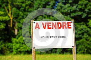 Sign showing the text - for sale with country land