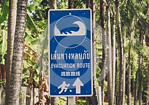 A sign showing a tsunami evacuation route at island in Thailand