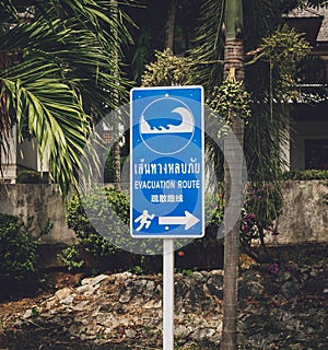 A sign showing a tsunami evacuation route at island in Thailand