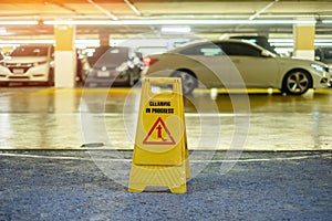 Sign showing warning of caution wet floor in garage building