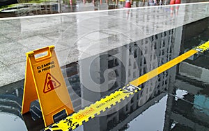 Sign showing warning of caution wet floor and mind the step