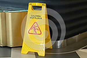 Sign showing warning of caution wet floor outdoors