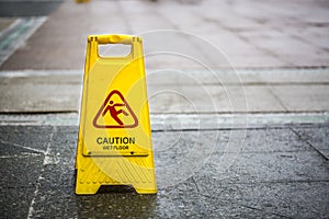 Sign showing warning of caution wet floor outdoors