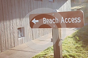 Sign showing the way to Beach Access. Sunflare, taken during golden hour