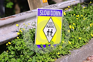 Sign slow down kids playing