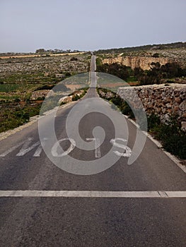 Sign slow on a long rural road