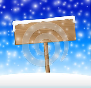 Sign on snow meadow with falling snow