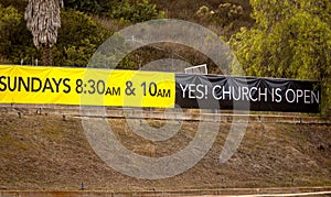 Sign Stating Church Is Now Open in black background