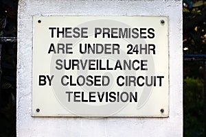 Sign stating that closed circuit television is surveilling the premises