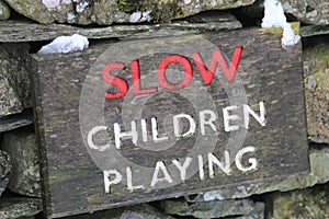 Sign stating SLOW CHILDREN PLAYING