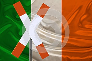 Sign, stop, attention on the background of the silk national flag of Ireland, the concept of border and customs control, violation