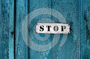 Sign ''stop'' on the grunge wooden door