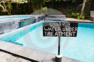 A sign beside swimming pool photo
