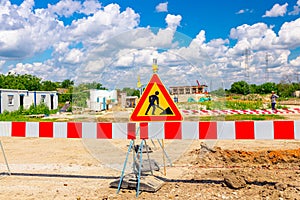 Sign with symbol of warning at construction zone area