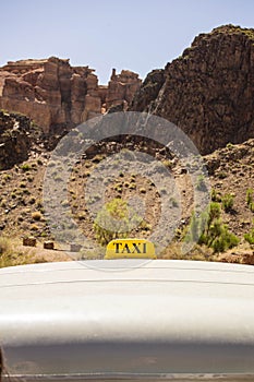 Sign of a taxi on an off-road jeep bringing people up in a mountainous area