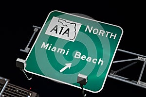 Sign to A1A north to Miami Beach lit at night