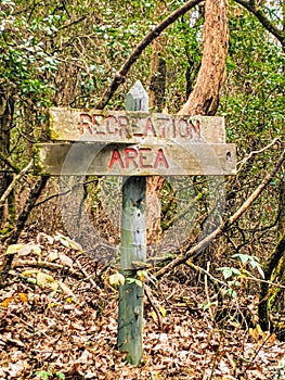 Sign on a trail through a forest