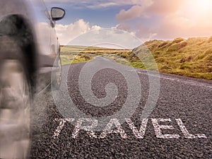 Sign travel on small asphalt country road and a side of a car in motion blur and smoke under tires. Travel and explore concept.