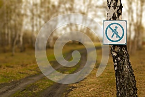 The sign on the tree prohibits invasion of the territory. Movement restrictions concept photo
