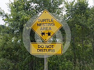 Sign turtle nesting area do not disturb at a city park with pond and marsh area.