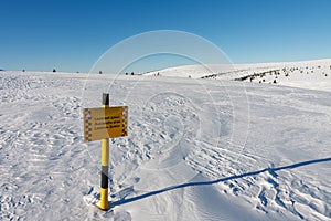 A sign warning of the avalanche area, white elbe valley, krkonose mountains, winter day