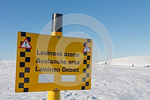 A sign warning of the avalanche area, white elbe valley, krkonose mountains, winter day. Avalanche area warning sign in czech,