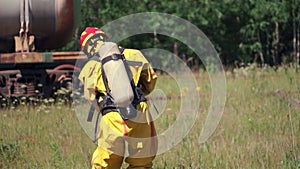 A sign warning of danger. Clip. People performing work in a dangerous area going to a gas mask on the background of a