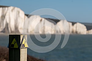 Sign warning of the danger of erosion at the cliff edge overlooking Seven Sisters at Seaford in East Sussex, south coast of UK