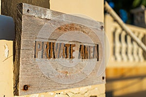 A sign warning about entering a private area, hanging on the fence of the property