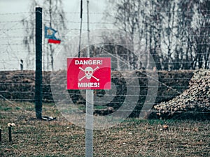 A sign warning of mines in front of the line of demarcation. Security checkpoint of the peacekeeping forces