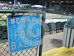 Sign warning to beware of foul balls at a minor league ballpark