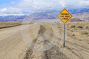 A sign warns of possible sink holes ahead