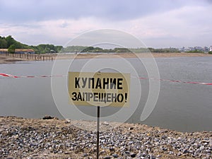 The sign warns swimming is forbidden on the beach you can not go into the water