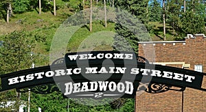 Sign welcome tourists to historic Main Street in Deadwood, SD
