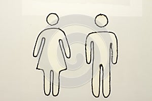 Sign of woman and man on glass.