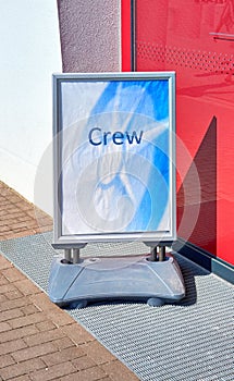 Sign with the word Crew in front of the entrance to an airport or cruise ship port