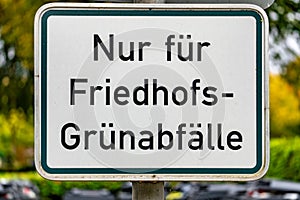 A sign with the word Friedhofs-Grunabfallle written on it